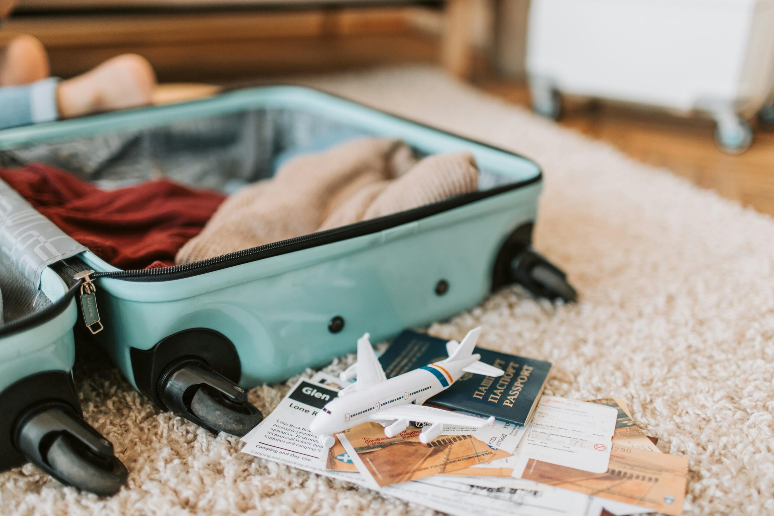 pexels photo 7368191 7368191 Close-up of an open suitcase with travel essentials like passport and tickets, ready for a journey.